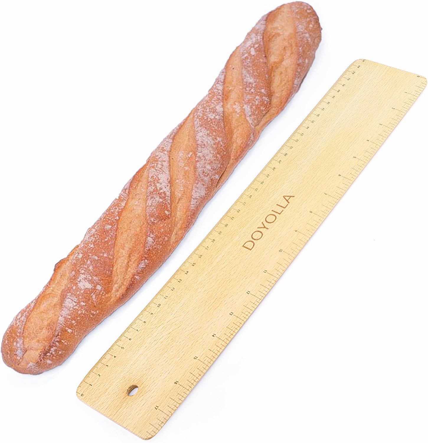 DOYOLLA pine wood baking peel in a home kitchen with a baguette ready to be transferred