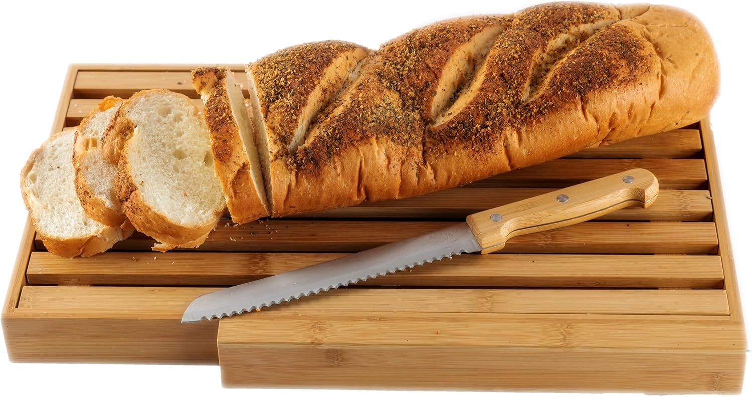 Yellow bamboo bread board with knife on a kitchen counter